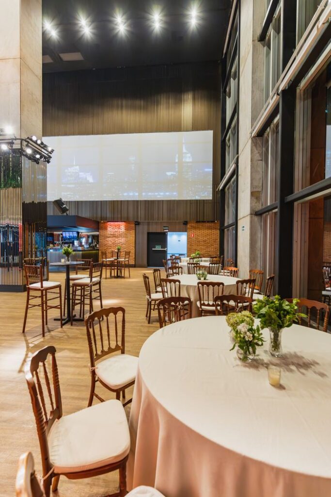 Mastering the First Impression: Your intriguing post title goes here Spacious banquet hall with round tables and floral decor, ideal for celebrations or gatherings.