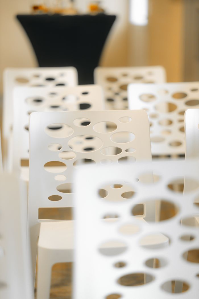 The Art of Drawing Readers In: Your attractive post title goes here Modern white chairs with artistic design in an indoor conference venue.